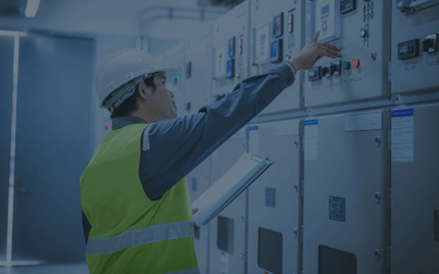 Engineer inspecting electrical switchgear panels